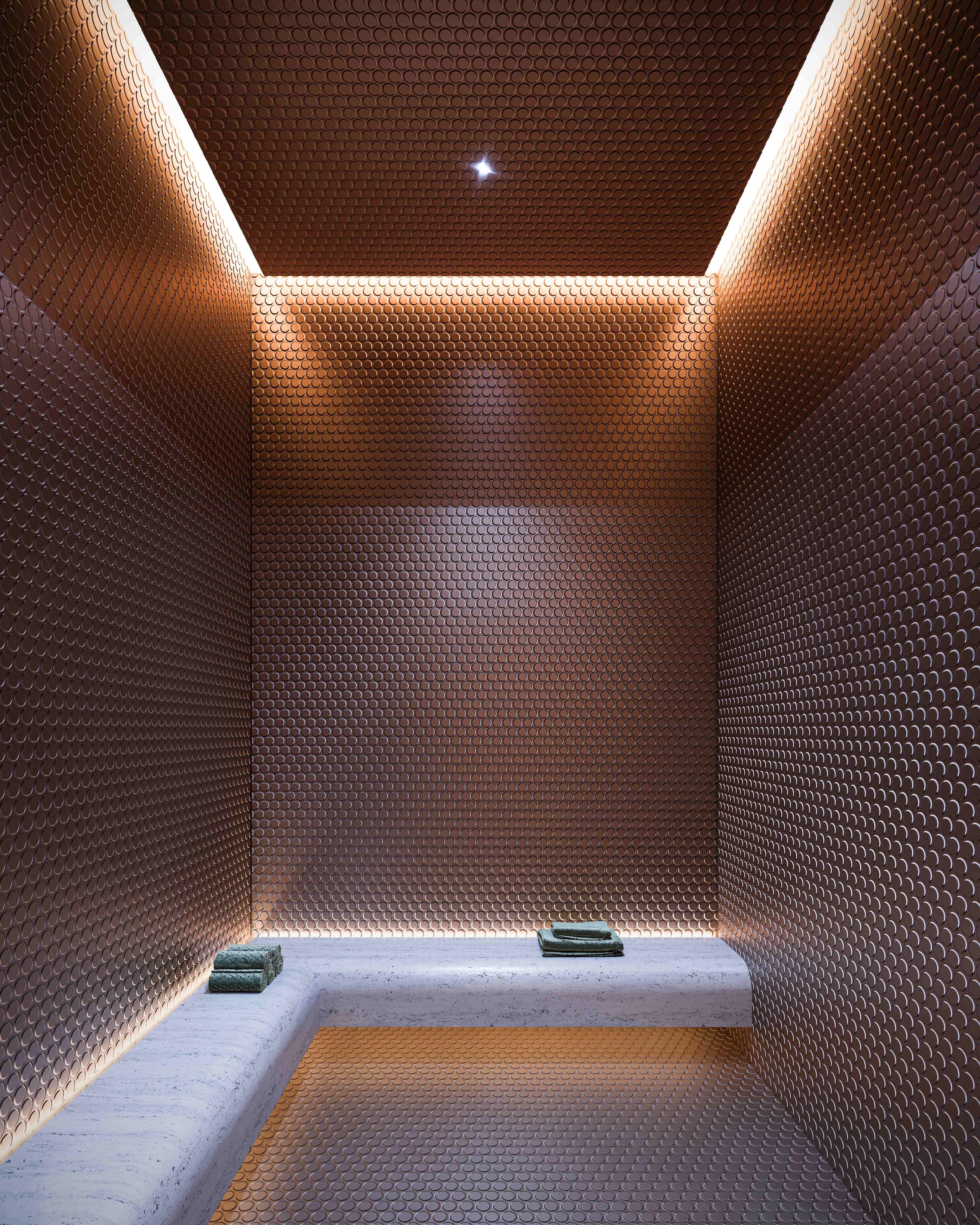 Luxurious steam room with geometric copper hexagonal tile pattern